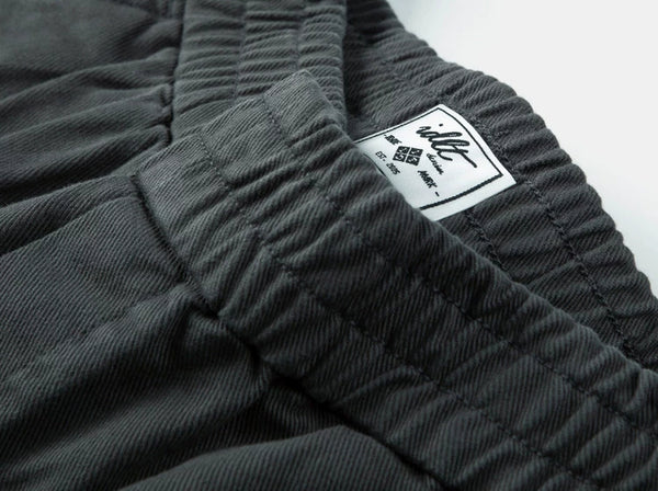 IDLT elastic waist trousers, dark gray waistband label.