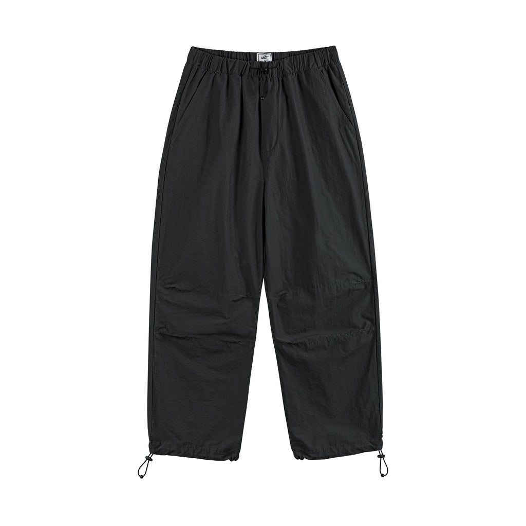 IDLT drawstring trousers, black front.