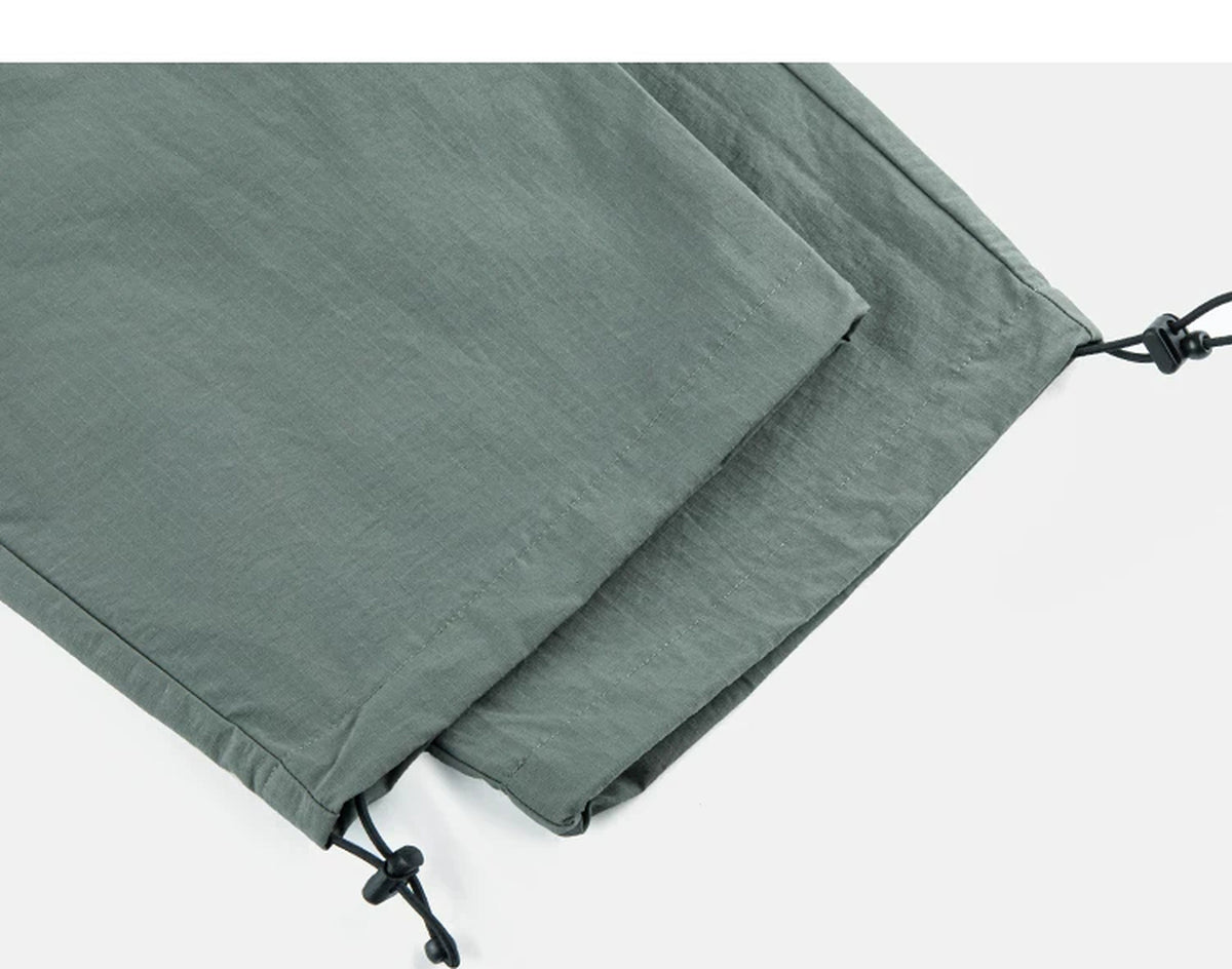 IDLT drawstring trousers, green leg hems.