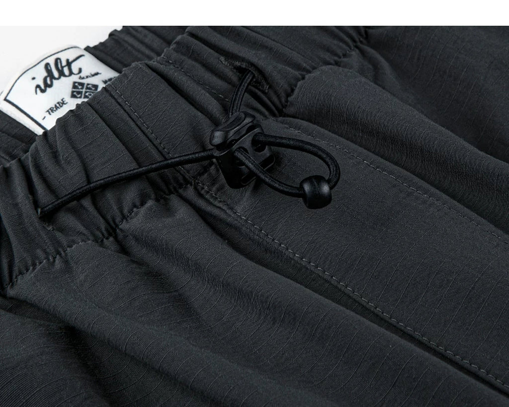 IDLT drawstring trousers, black waist drawcord.
