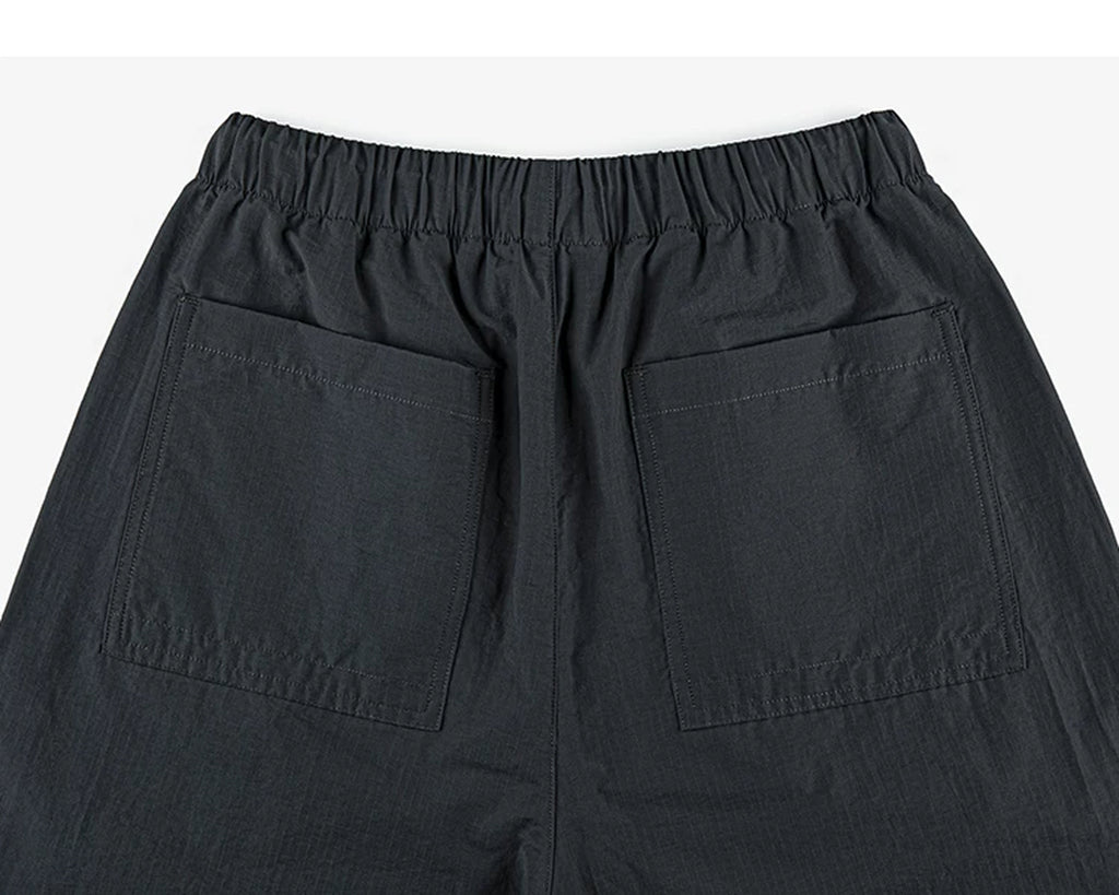 IDLT drawstring trousers, black back pockets.