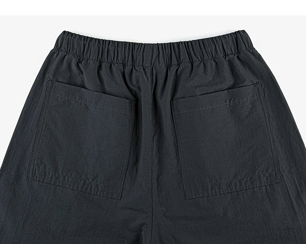 IDLT drawstring trousers, black back pockets.