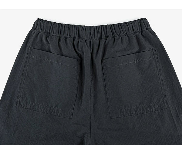 IDLT drawstring trousers, black back pockets.