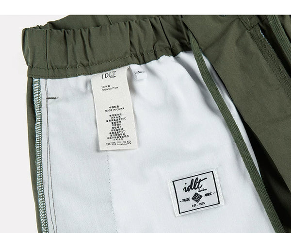 IDLT cargo pants, green inner care label.