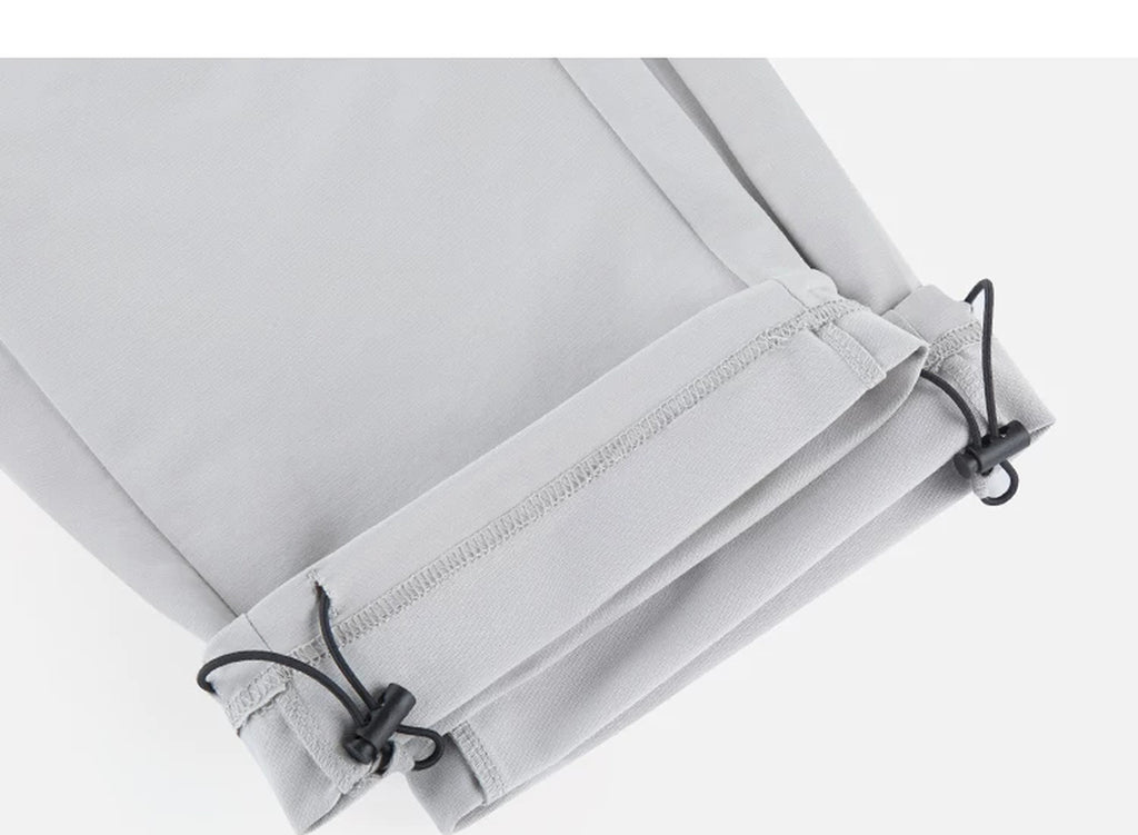 IDLT drawstring trousers, light gray ankle drawcords.