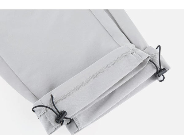 IDLT drawstring trousers, light gray ankle drawcords.