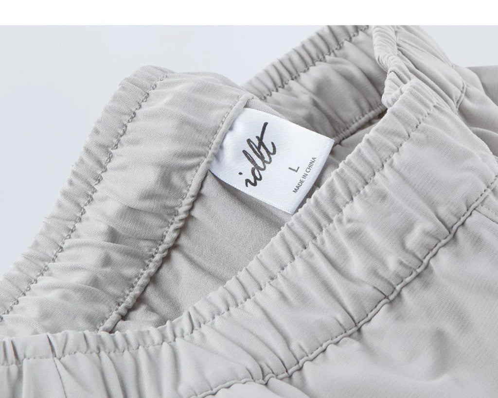 IDLT drawstring trousers, light gray waistband label.