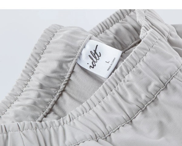 IDLT drawstring trousers, light gray waistband label.