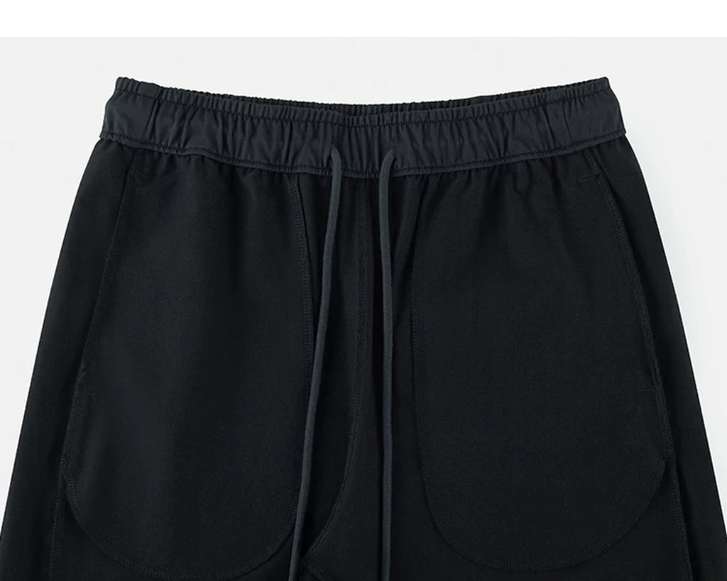IDLT drawstring trousers, black inner pockets.