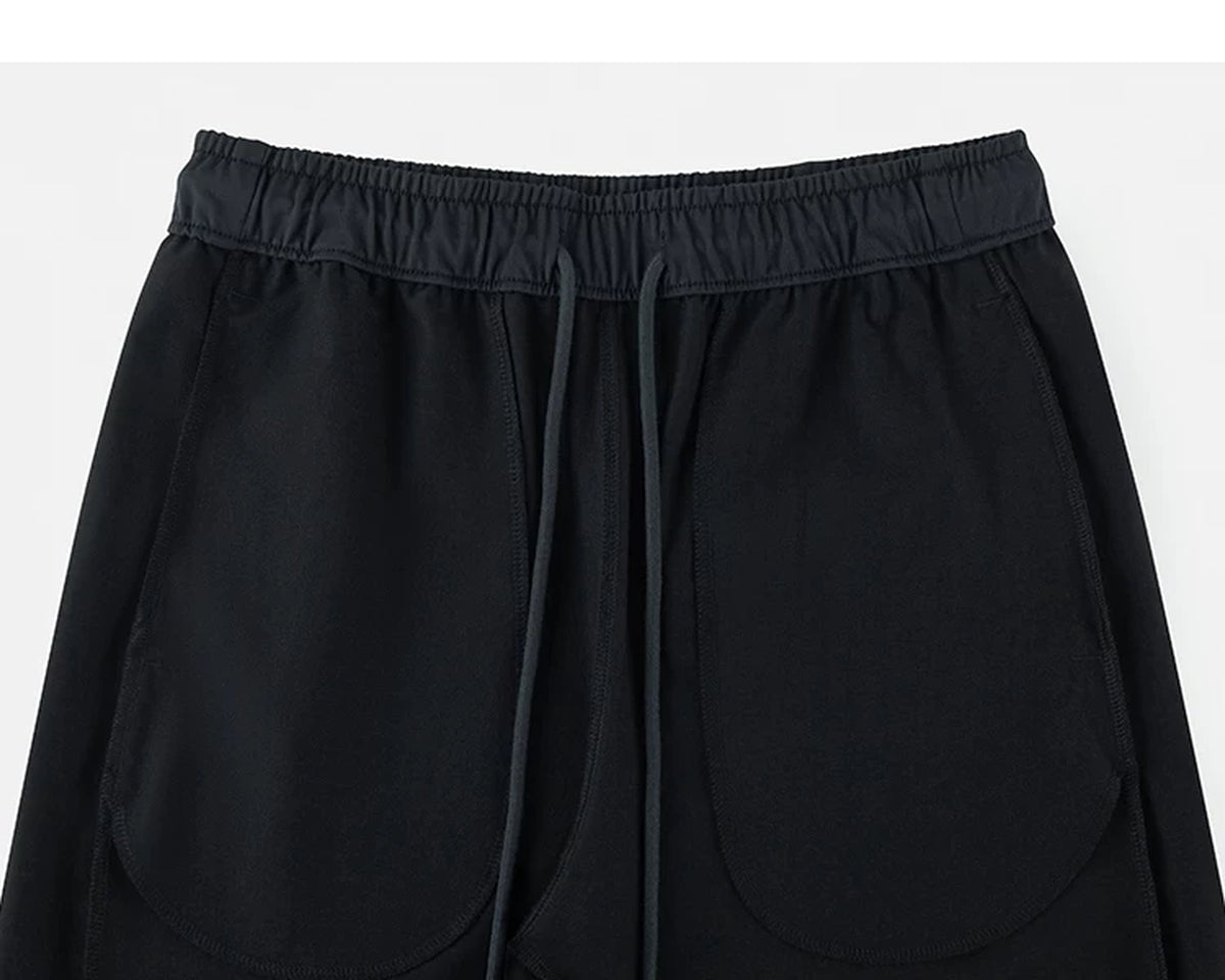 IDLT drawstring trousers, black inner pockets.