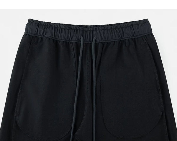 IDLT drawstring trousers, black inner pockets.