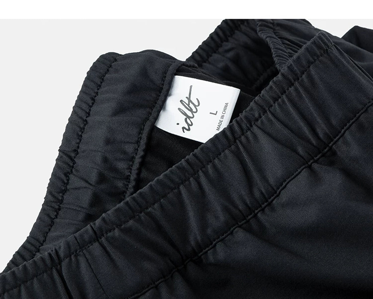 IDLT drawstring trousers, black waistband label.