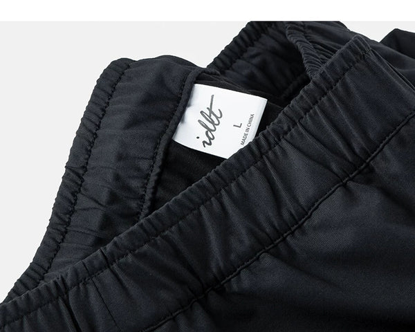 IDLT drawstring trousers, black waistband label.