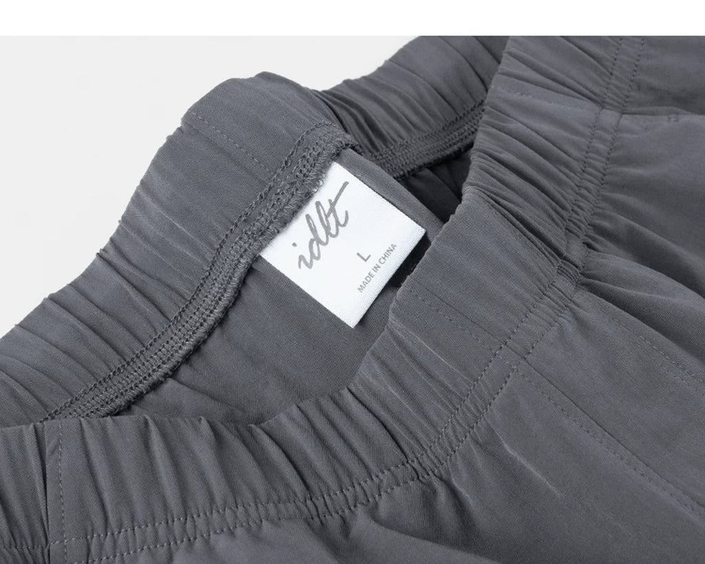 IDLT shorts, gray waistband label.