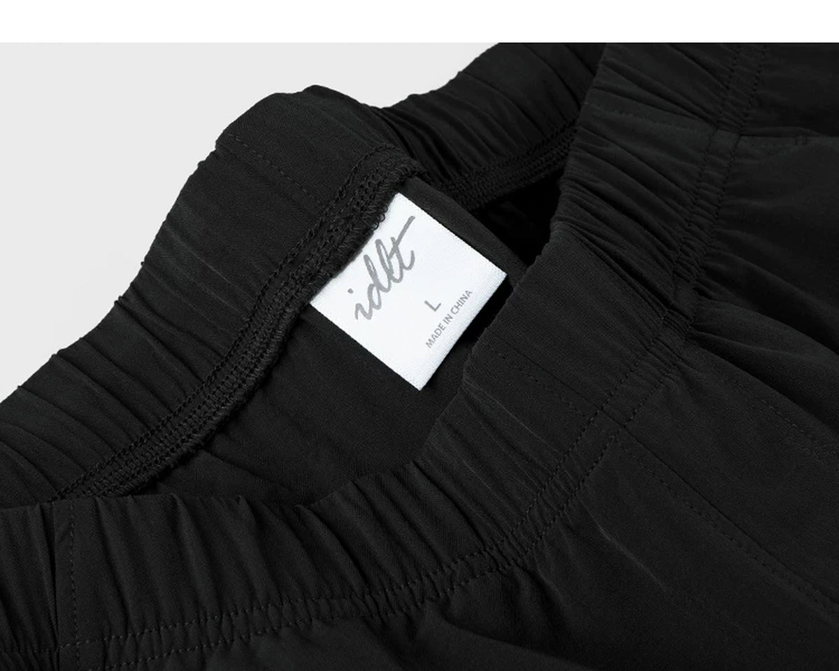IDLT shorts, black waistband label.