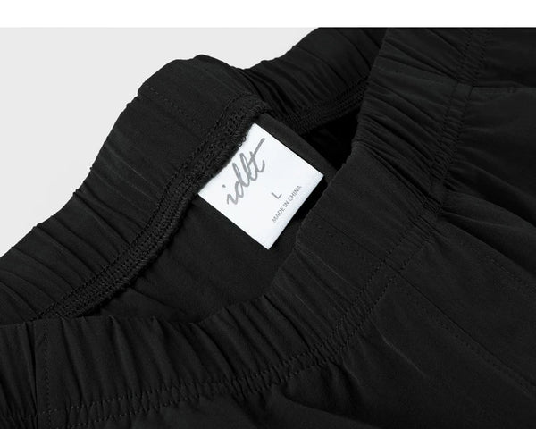 IDLT shorts, black waistband label.