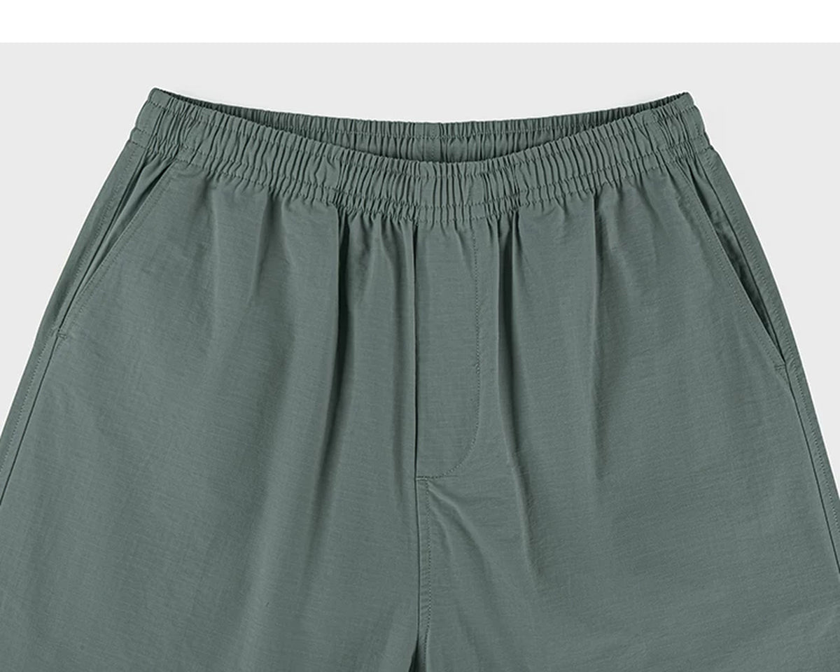 IDLT shorts, green waistband.