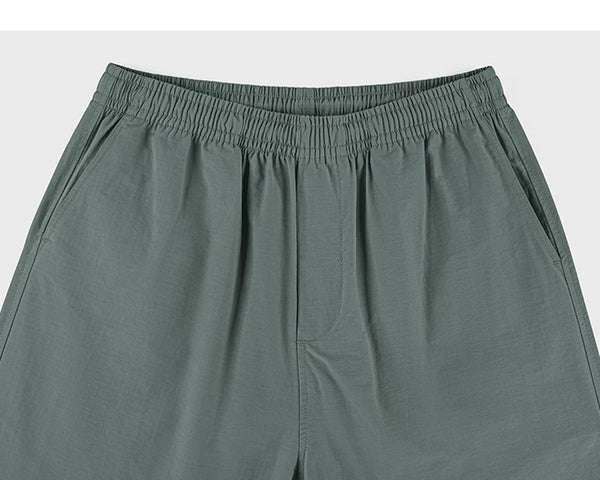 IDLT shorts, green waistband.