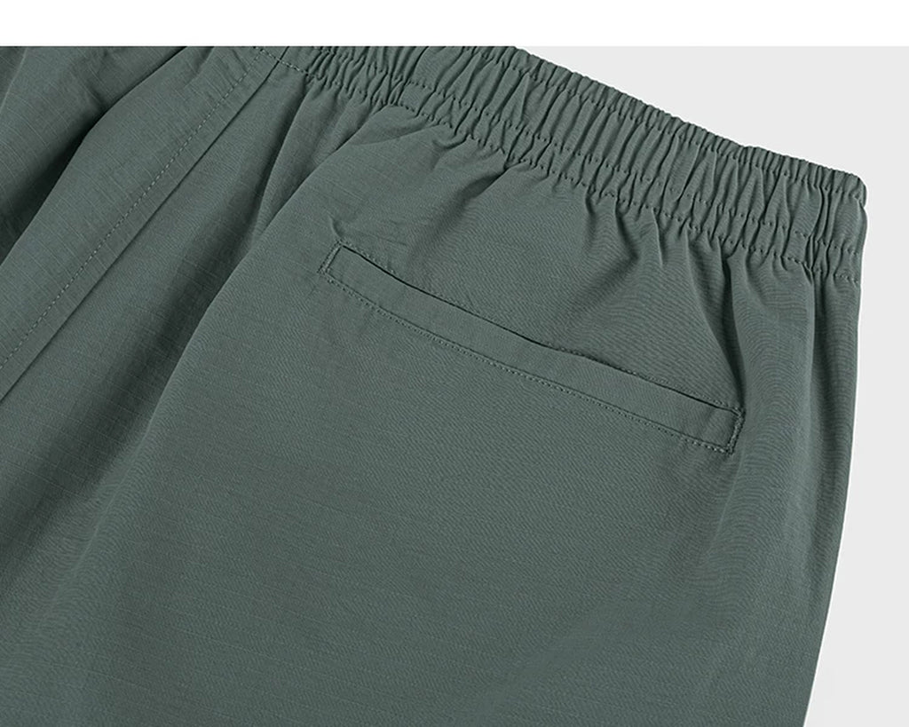 IDLT shorts, green back pocket.