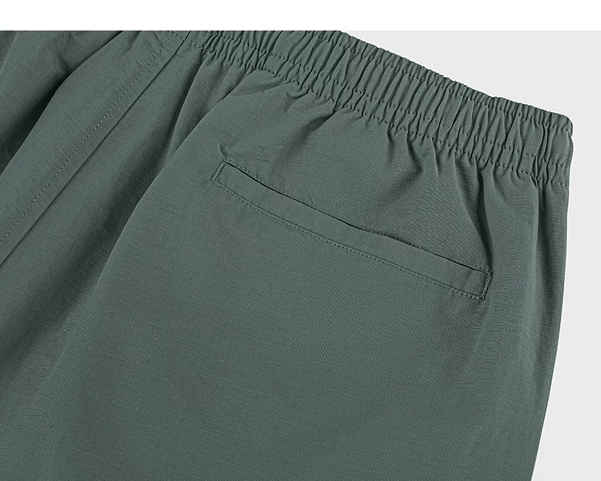 IDLT shorts, green back pocket.