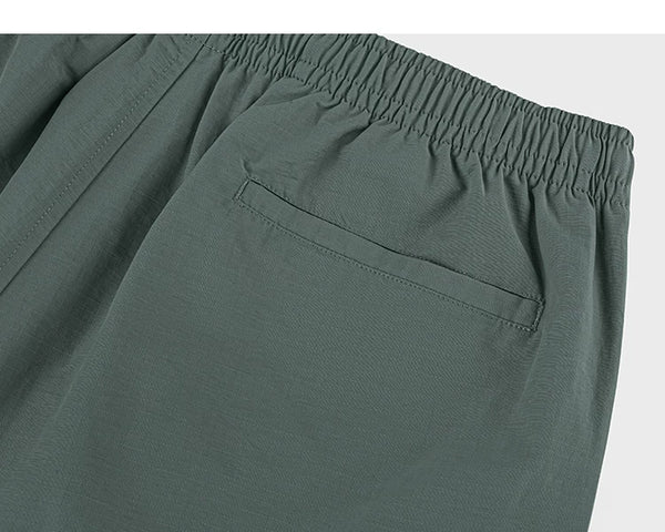 IDLT shorts, green back pocket.