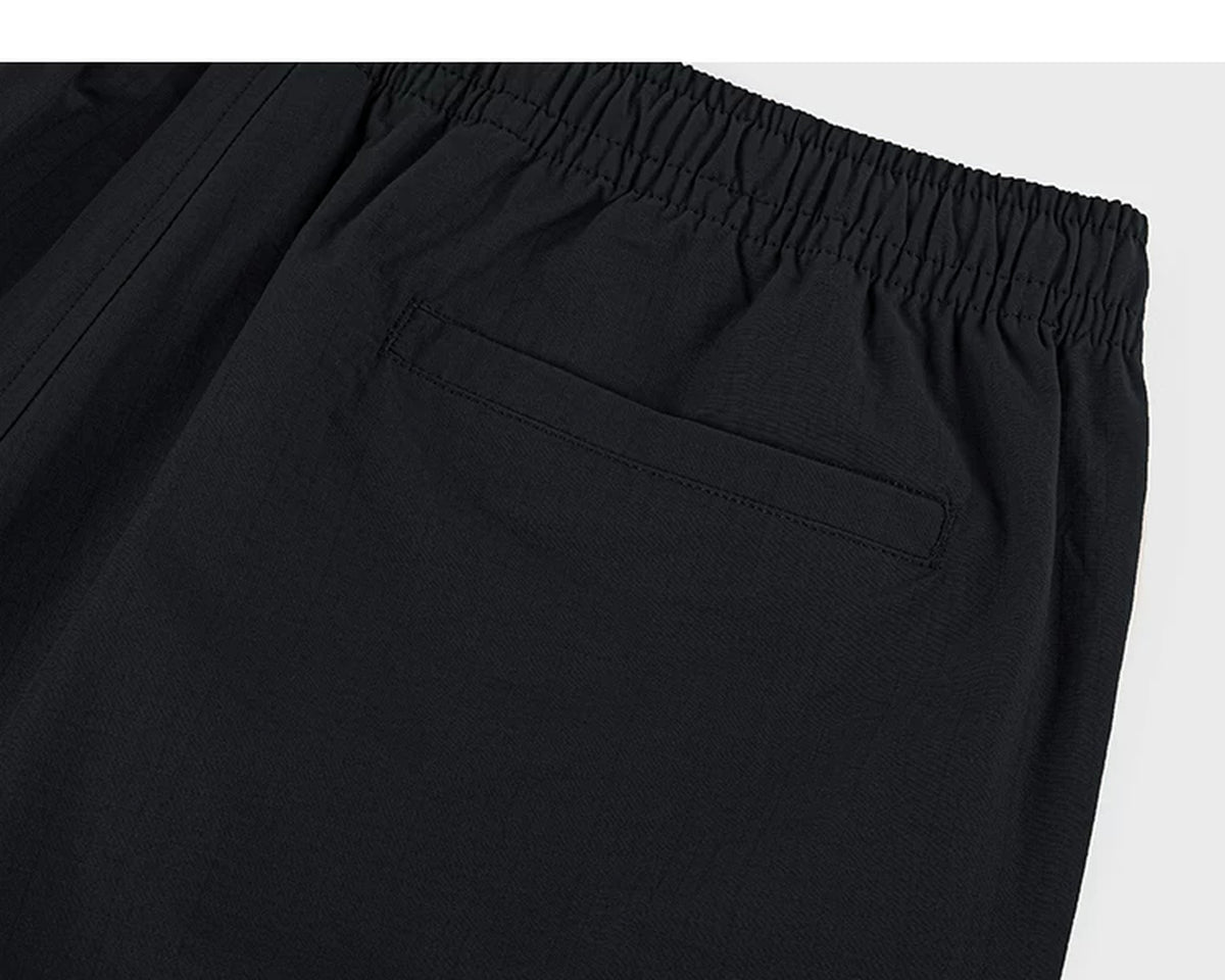 IDLT shorts, black back pocket.