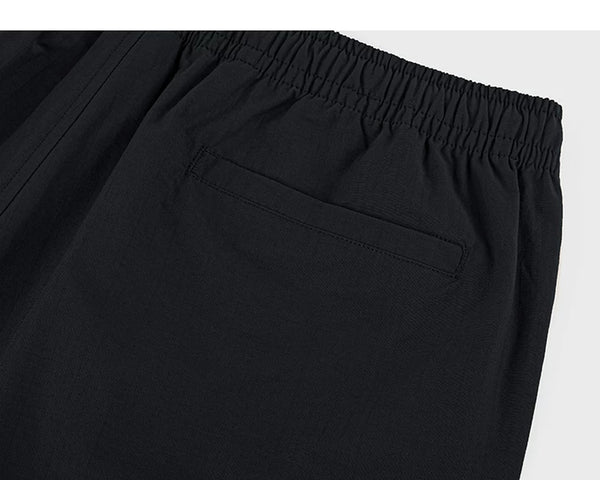 IDLT shorts, black back pocket.