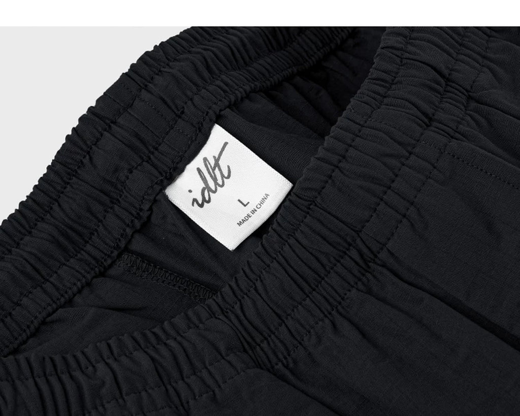 IDLT shorts, black waistband label.