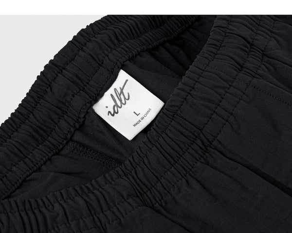 IDLT shorts, black waistband label.