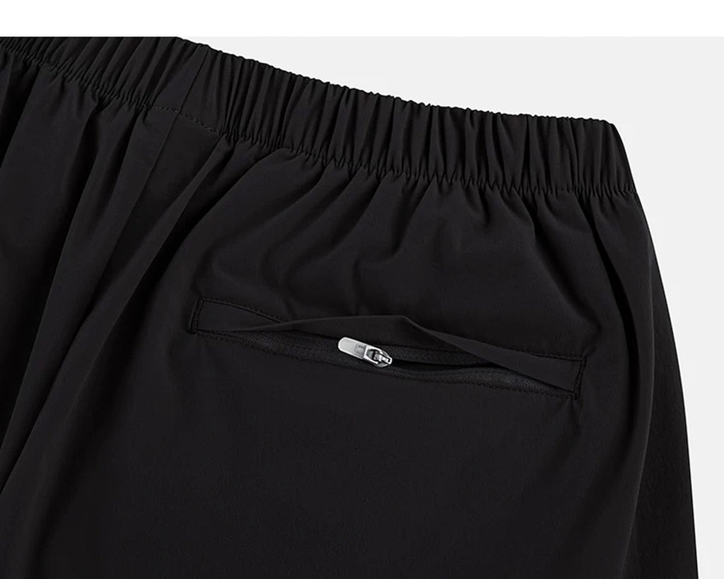 IDLT shorts, black zipped back pocket.