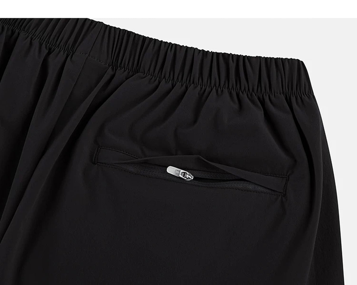 IDLT shorts, black zipped back pocket.
