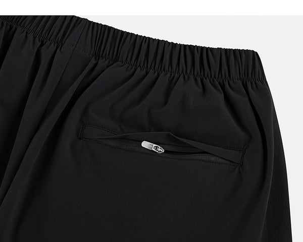 IDLT shorts, black zipped back pocket.