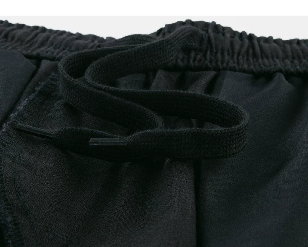 IDLT shorts, black inner drawstring.