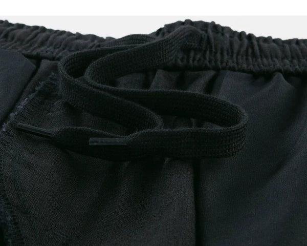 IDLT shorts, black inner drawstring.