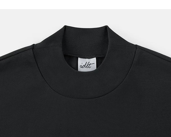 IDLT mock neck T-shirt, black collar.