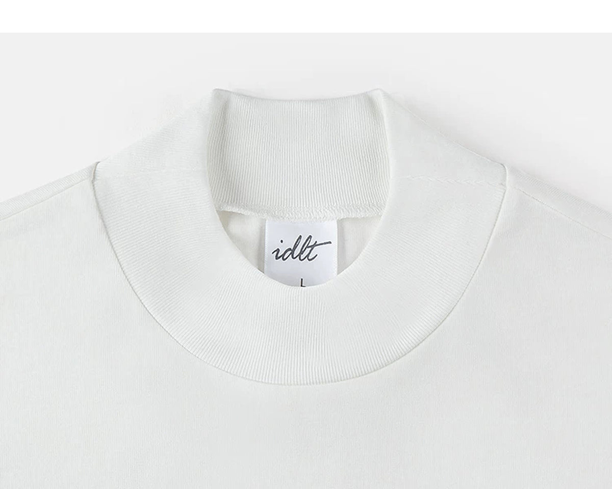 IDLT mock neck long sleeve top, white collar.