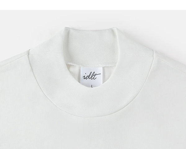 IDLT mock neck long sleeve top, white collar.
