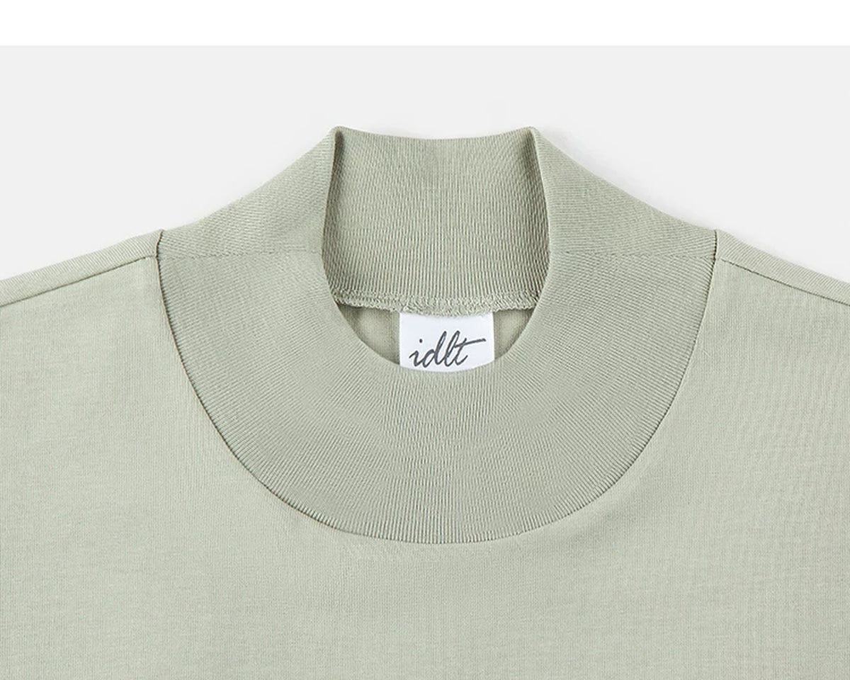 IDLT mock neck long sleeve top, sage green collar.
