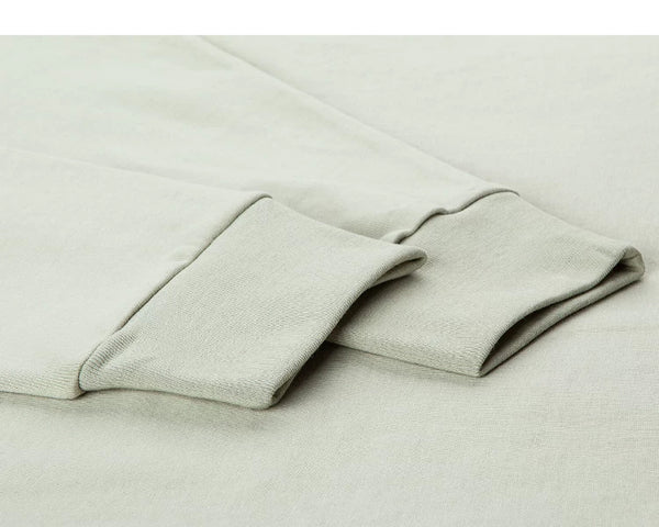 IDLT mock neck long sleeve top, sage green ribbed cuffs.