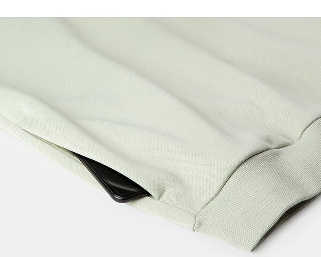 IDLT hoodie, sage green side pocket.