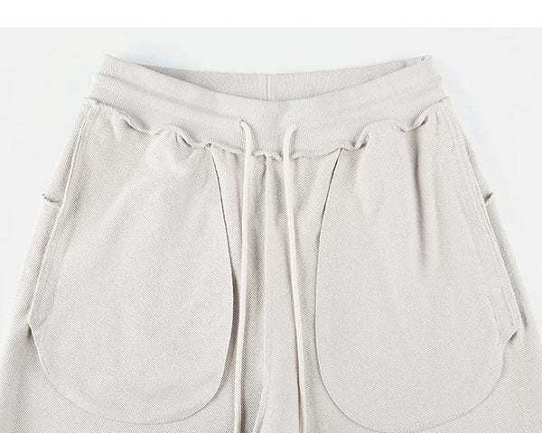 IDLT sweat shorts, cream inner pockets.