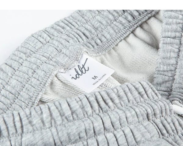 IDLT sweat shorts, heather gray waistband label.