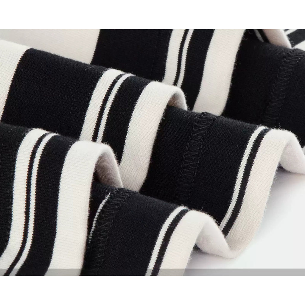 IDLT striped T-shirt, black and cream fabric folds close-up.