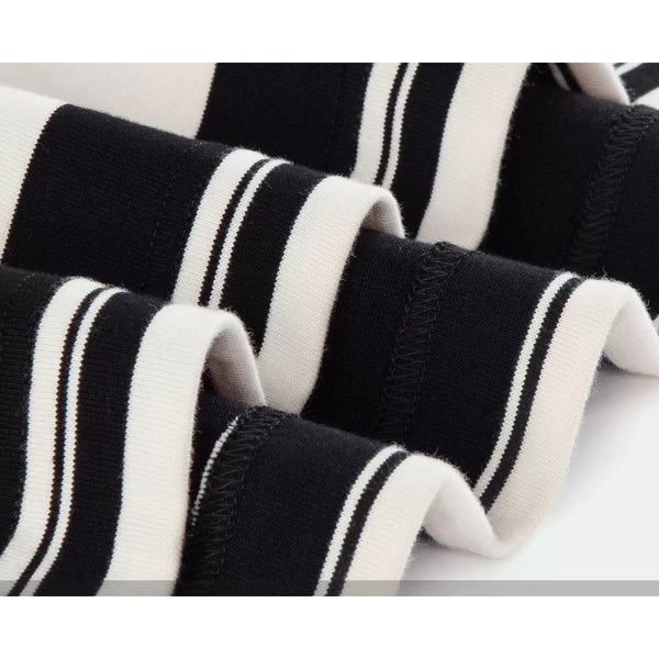 IDLT striped T-shirt, black and cream fabric folds close-up.