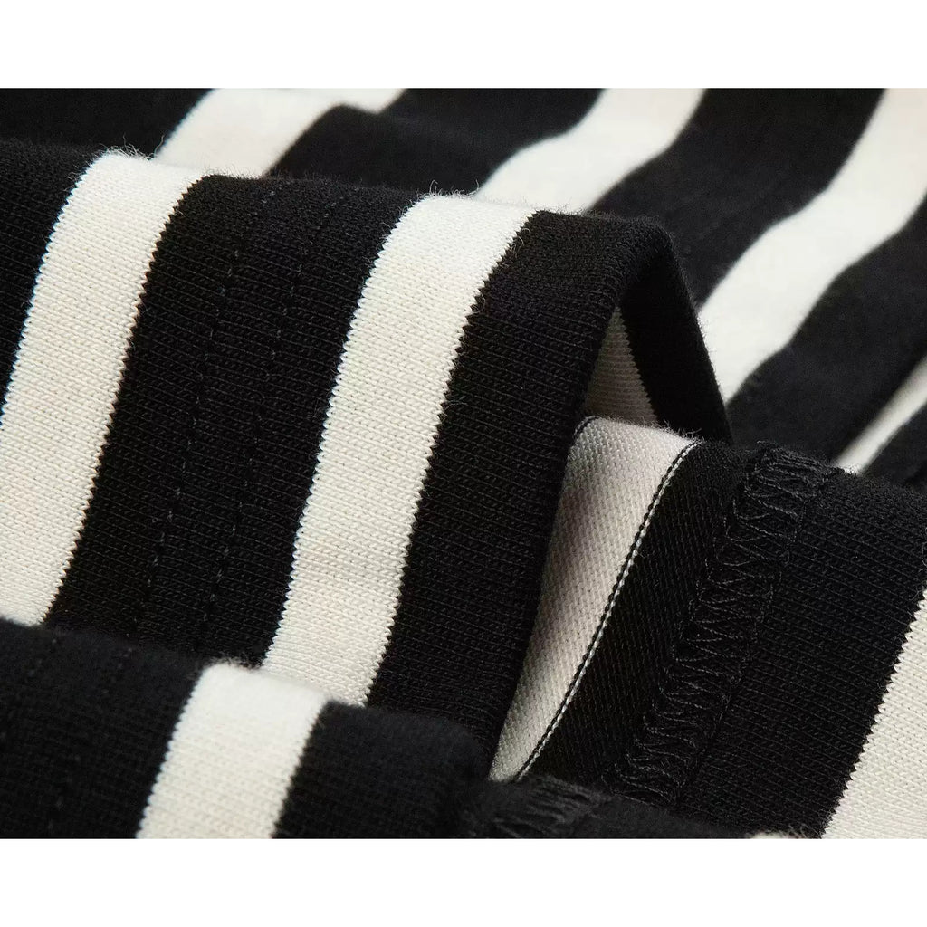 IDLT striped T-shirt, black and cream fabric folds close-up.