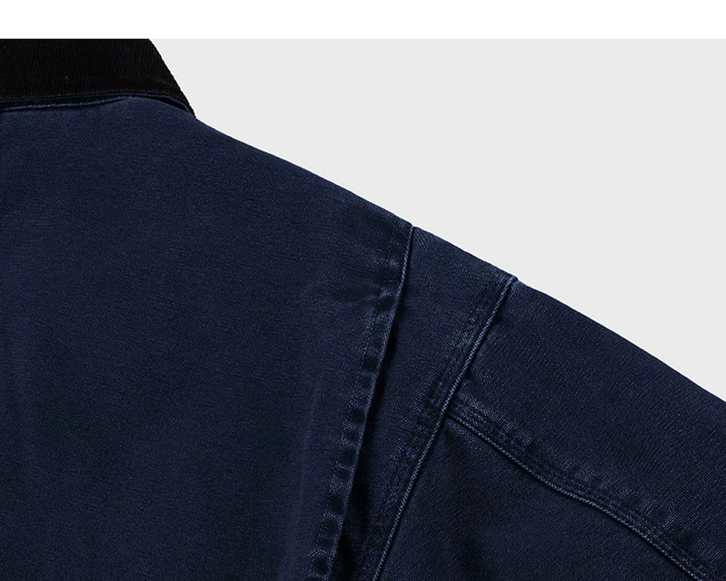 IDLT work jacket, navy shoulder seam.