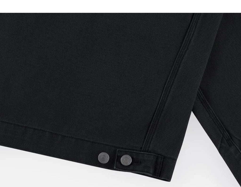 IDLT work jacket, black hem adjustment tab.
