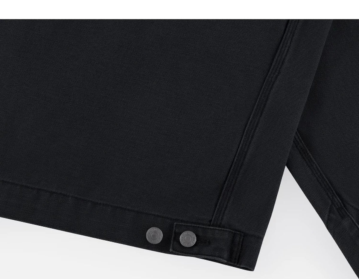 IDLT work jacket, black hem adjustment tab.