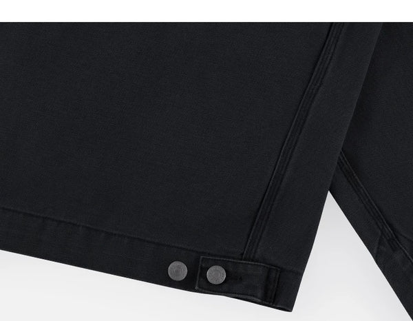 IDLT work jacket, black hem adjustment tab.