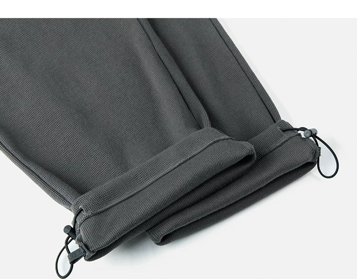 IDLT waffle sweatpants, dark gray rolled hems.